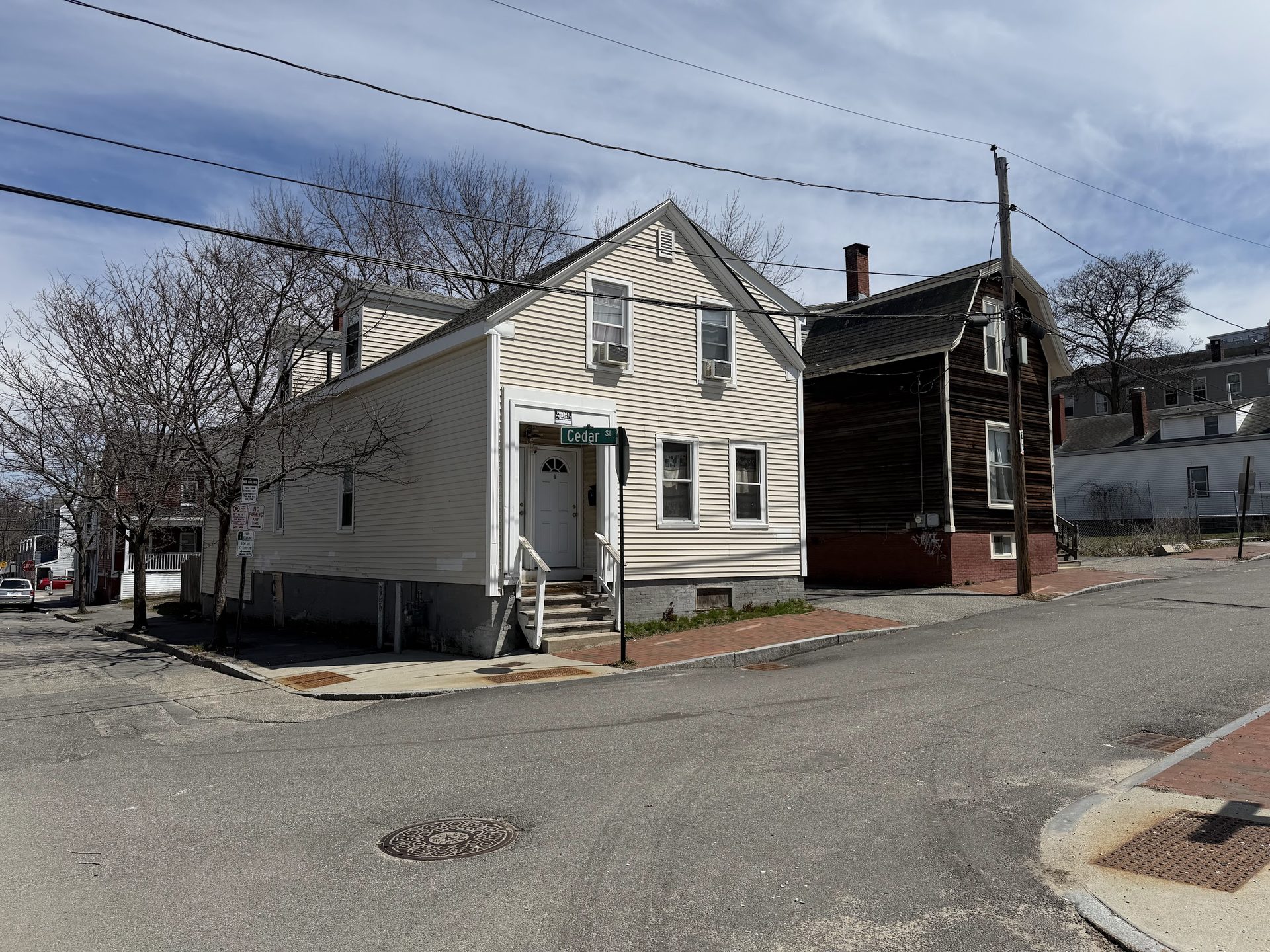 Street-level view of 25 Cedar — two-unit at the corner with Cedar.