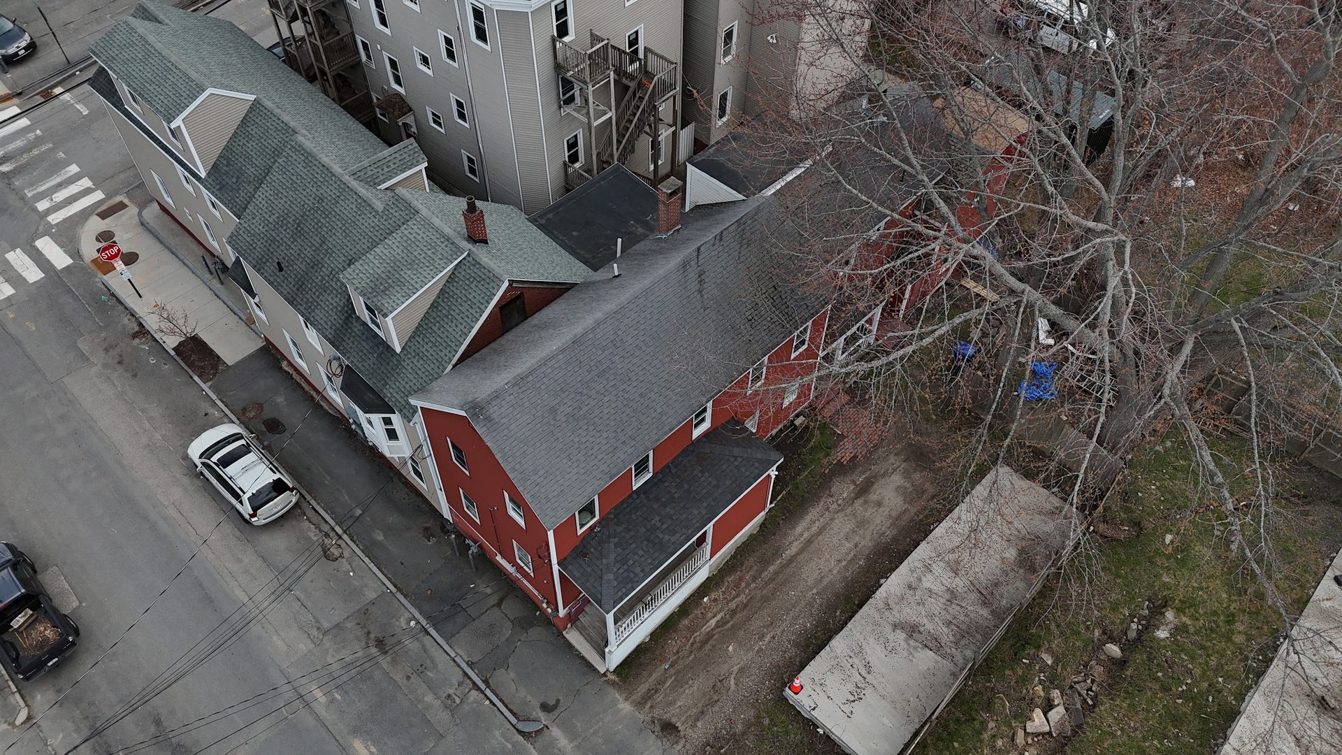 Aerial view looking along Cedar Street with the red two-unit at 25 Cedar in the foreground.